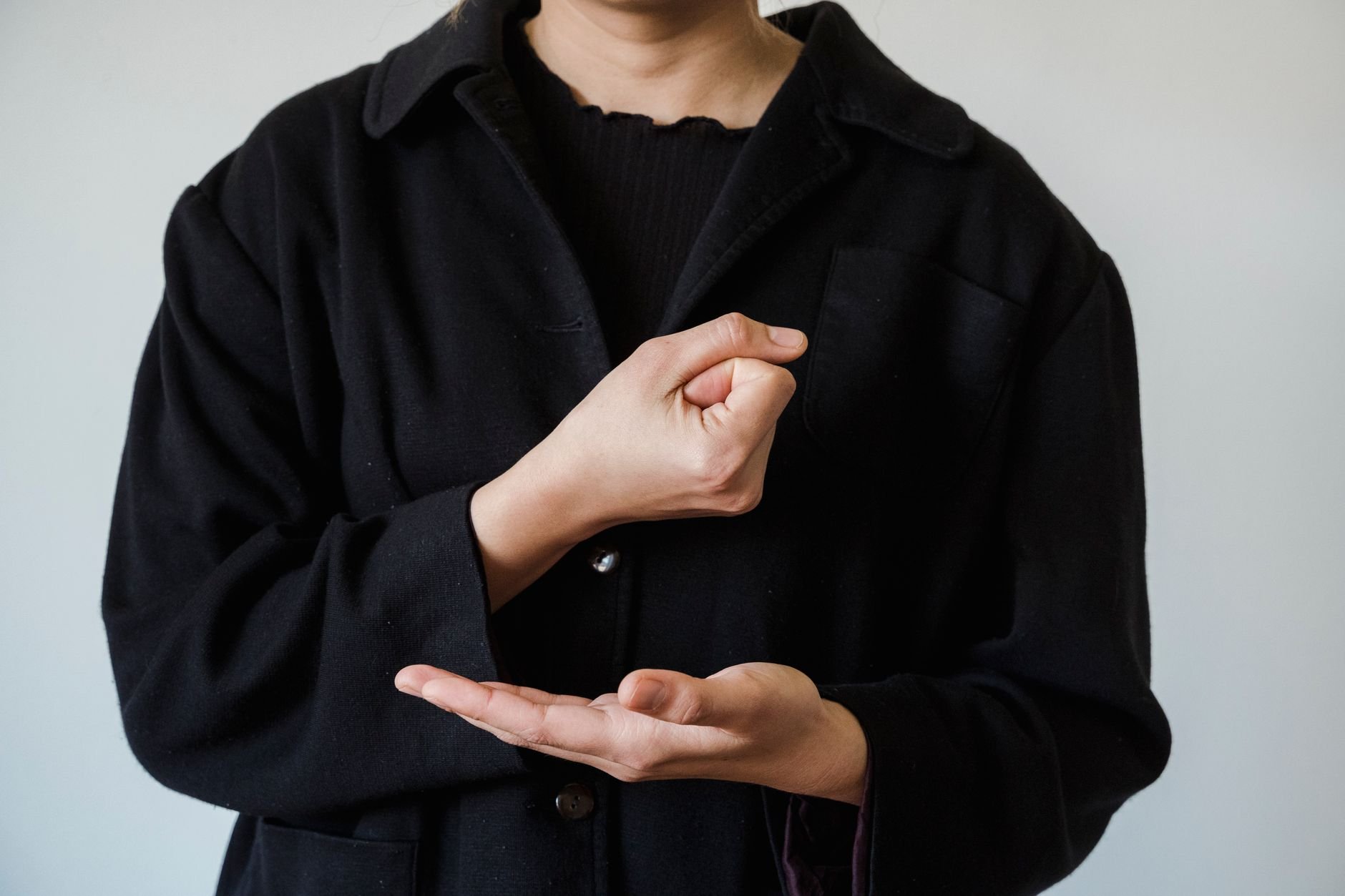 Person demonstrating American Sign Language hand gestures