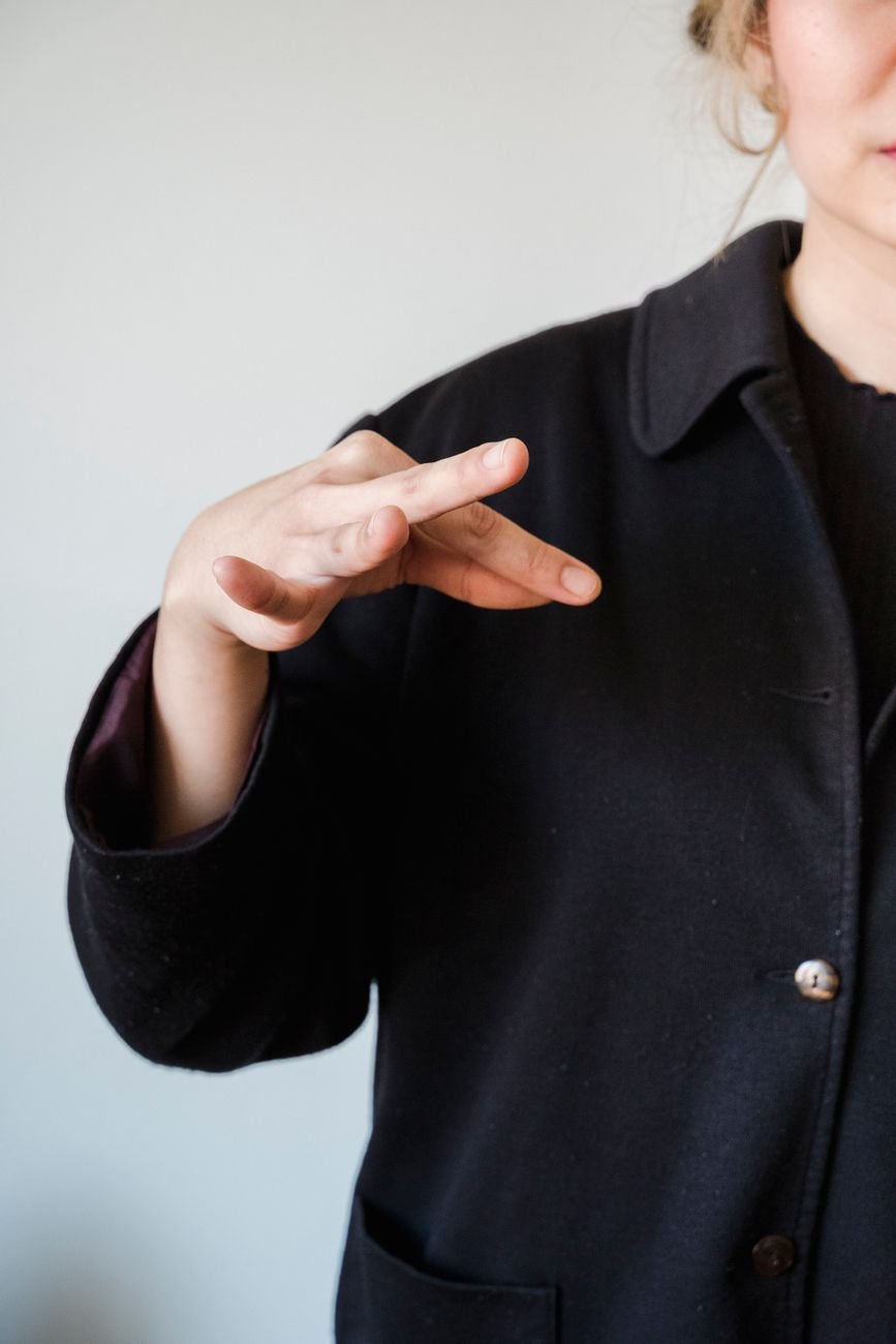 A woman using sign language indoors